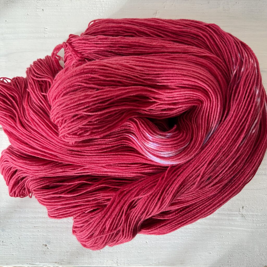 ベリーレッドの手染め毛糸のカセをほどいた色の入り方